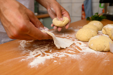 man preparing dough with flour