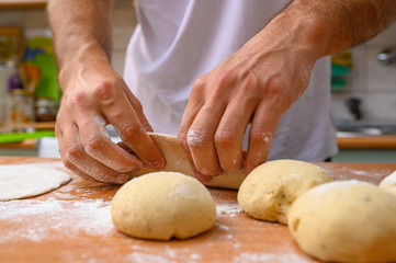 man preparing dough with flour