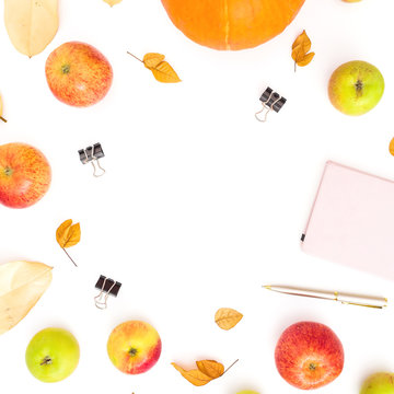 Autumn composition of fall leaves, apple and pumpkin with notebook, pen and clips on white background. Thanksgiving day concept. Flat lay, top view