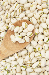 Pistachio nuts with wooden spoon