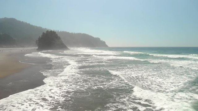 Aerial footage of the beach and rocky cliffs of the Oregon coast near Lincoln City.