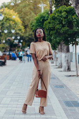 Outdoor full fashion portrait of fashionable black woman skin