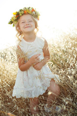 Little girl with flowers on her head. 
