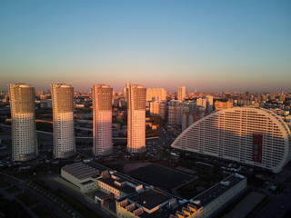 Obraz premium Cityscape with four high-rise residential buildings and city blocks in the evening. Aerial view