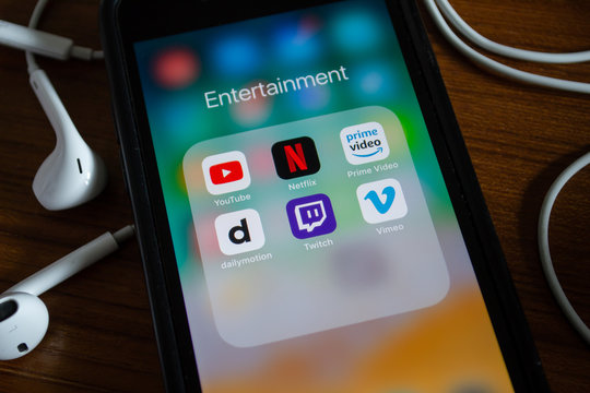 Bangkok, Thailand - June 10, 2019 : iPhone 7 showing its screen with YouTube, Netflix and other video streaming applications.