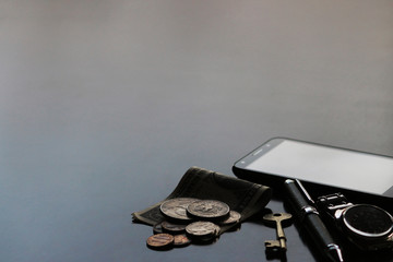 Still life of male cool belongings with dollar bills and coins