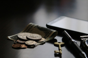 Still life of male cool belongings with dollar bills and coins