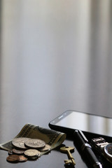 Still life of male cool belongings with dollar bills and coins