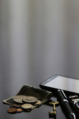 Still life of male cool belongings with dollar bills and coins