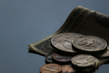 Shabby dollar bills and coins still life