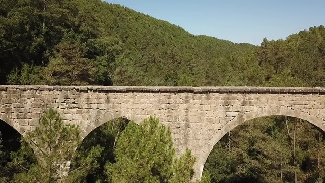 Aerial view of the Pont de la Frau aqueduct in Solsona, Catalonia, Spain, Europe.
Dolly shot flying over the bridge.