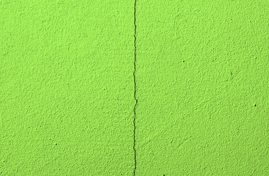 Fragment of an old green cracked wall