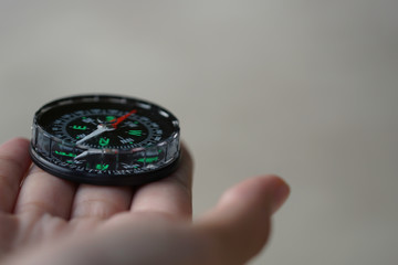 A compass on a beach sand. Selective focus to the compass