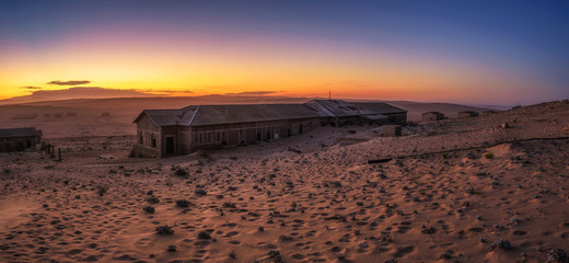 Sunrise above the abandoned houses of Kolmanskop ghost town, Namibia.