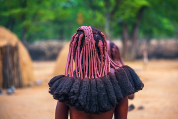 Traditional hairstyle of women in the Himba tribe photographed from behind