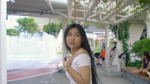 Thai Girl turns and gets afraid of bee. Slow motion