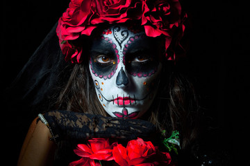 Portrait of woman dressed as catrina, skull to honor the dead in Mexico.