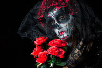 Portrait of woman dressed as catrina, skull to honor the dead in Mexico.