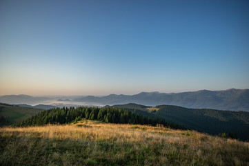 Fototapeta premium Misty summer morning in the mountains