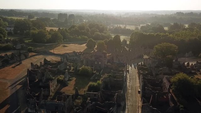 Aerial view of the Oradour Sur Glane war memorial. Hundreds of civillians were massacred by the German SS during world war 2.
Dolly shot backward over main street higher altitude.