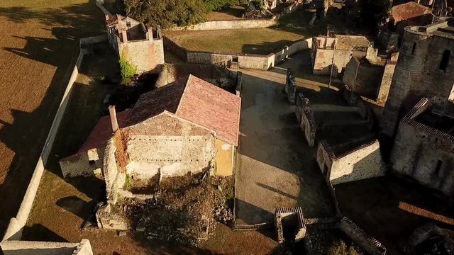 Aerial view of the Oradour Sur Glane war memorial. Hundreds of civillians were massacred by the German SS during world war 2.
Close up of a street followed by a reveal of the town.