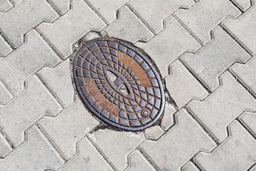 Fire hydrant, internal fire protection. Cast iron cover in the street.