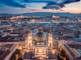 Obraz premium Budapest, Hungary - Aerial view about the towers of the famous St.Stephen's Basilica and Buda Castle, Chain Bridge, Matthias Church at cloudy sunset