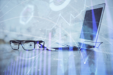 Forex Chart hologram on table with computer background. Multi exposure. Concept of financial markets.