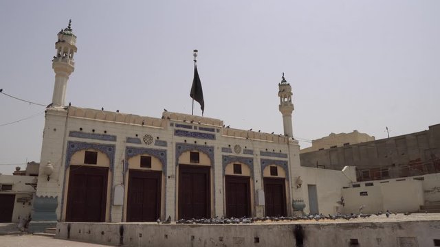 Multan Darbar Hazrat Yousaf Shah Gardez Tomb Square with Flock of Pigeons Side View on a Sunny Blue Sky Day