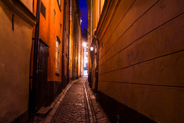 Fototapeta na wymiar The narrow cobblestone street with houses of Gamla Stan old center of Stockholm