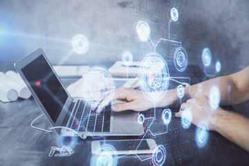 Businessman with computer background with technology theme hologram. Concept of hightech. Multi exposure.
