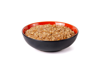 Sprouted wheat porridge in red and black bowl. Isolated on white background. Idea for healthy diet meal.