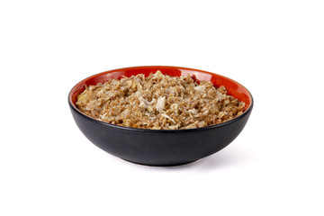 Sprouted wheat porridge with chicken meat in red and black bowl. Isolated on white background. Idea for healthy diet meal.
