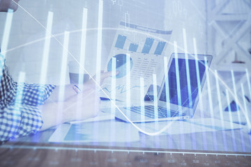 Multi exposure of financial graph with man works in office on background. Concept of analysis.