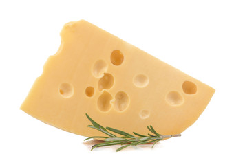 A slice of tasty Maasdam cheese with large holes and a sprig of razmarin on a white isolated background. close-up