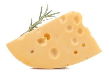 A slice of tasty Maasdam cheese with large holes and a sprig of razmarin on a white isolated background. close-up
