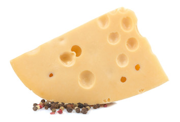 Slice of tasty Maasdam cheese with large holes and spices on a white isolated background. close-up