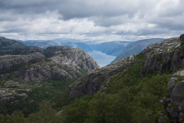 Naklejka premium Preikestolen massive cliff (Norway, Lysefjorden summer morning view). Beautiful natural vacation hiking walking travel to nature destinations concept. July 2019
