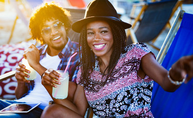 Romantic happy couple relaxing on the beach together - Powered by Adobe