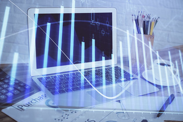 Forex Chart hologram on table with computer background. Double exposure. Concept of financial markets.