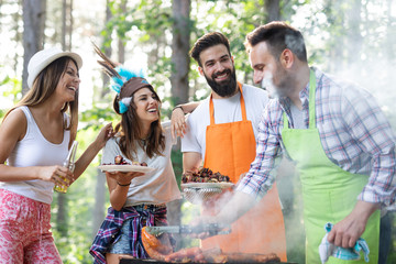 Group of friends having a barbecue party in nature