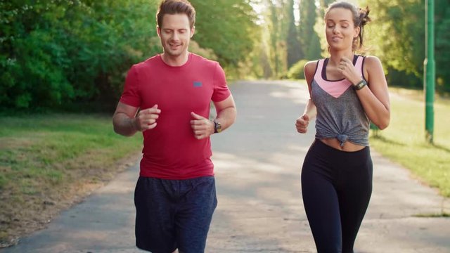 Tilt up of jogging young couple