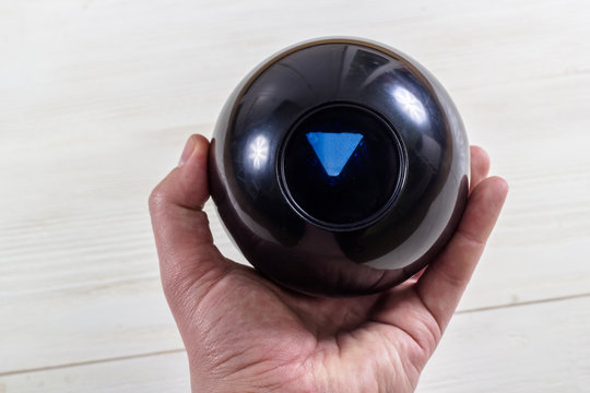 Magic prediction eight ball in hand.