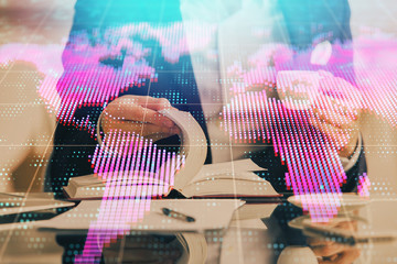Double exposure of hands and notepad with business icons.