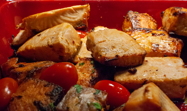 Fried pieces of salmon fish with cherry tomatoes