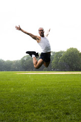 Long shot of man jumping in park