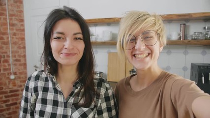 Girlfriends waving hands at camera