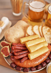 Sausage and cheese slices with light beer, pistachios, mustard and ciabatta bread for Oktoberfest