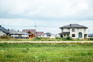 Fototapeta na wymiar Country houses under construction on green field.