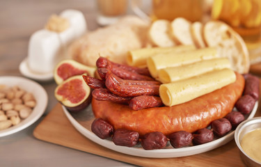 Sausage and cheese slices with light beer, pistachios, mustard and ciabatta bread for Oktoberfest